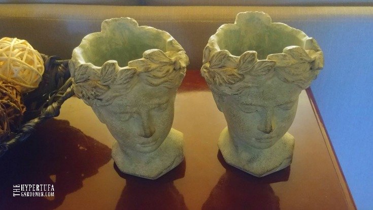 two  head vases with holes to use as planters