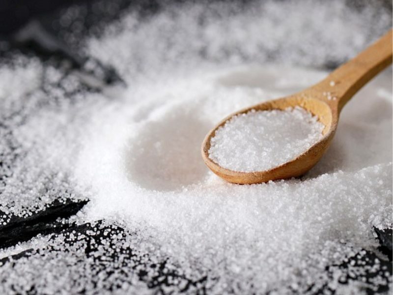 teaspoon of table salt on pile of salt crystals